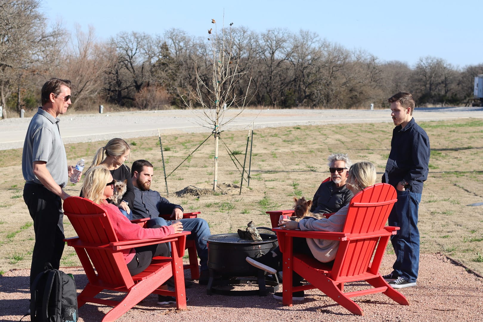 Friends gathered around a small fire pit Friends gathered around a small fire pit