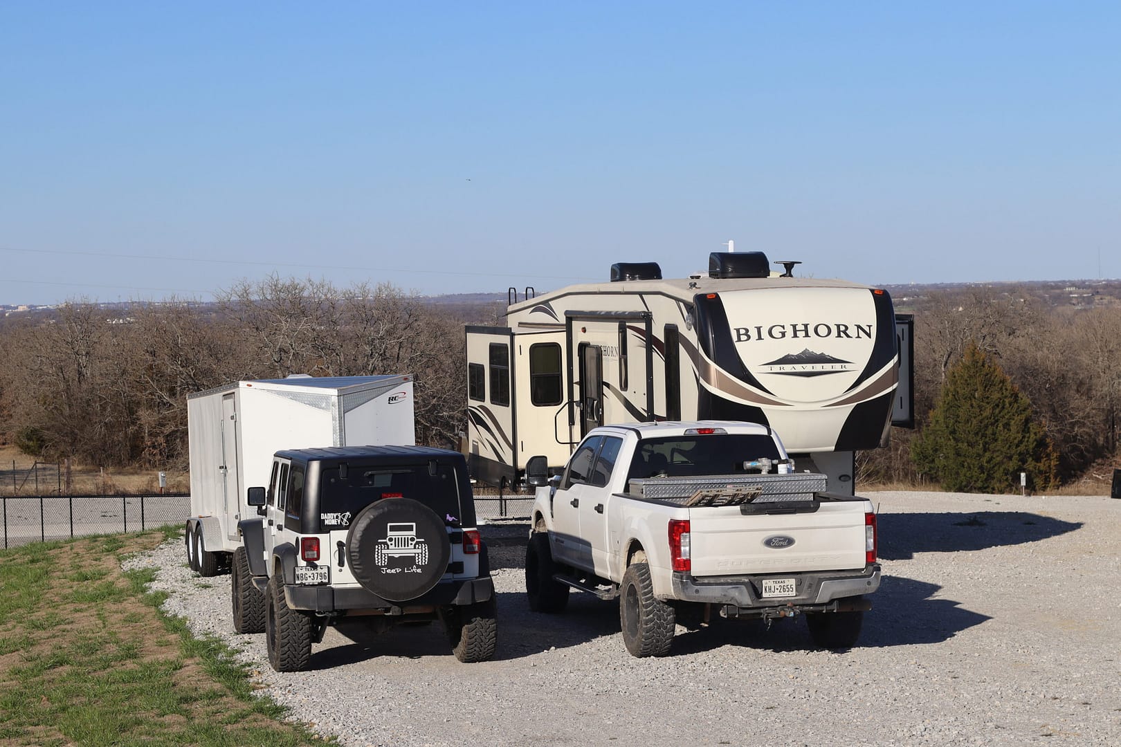 A truck and some cars parked on the side of a road. A truck and some cars parked on the side of a road.